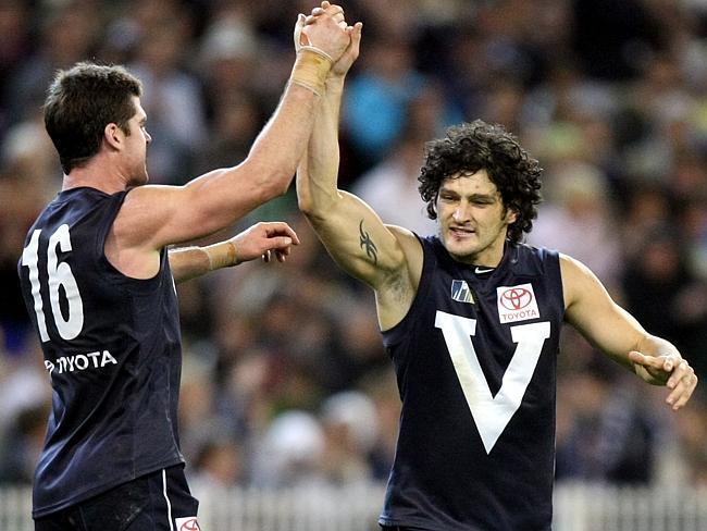 Jonathan Brown celebrates with Bendan Fevola after a goal during the AFL Hall of Fame Tribute Match between Victoria and the Dream Team from the MCG. 