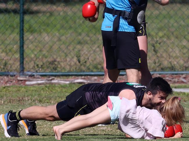 Trent Cotchin planks with his daughter Harper at training. Picture: Michael Klein