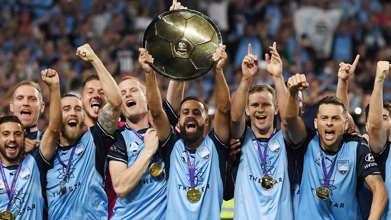 Sydney FC captain Alex Brosque hoists the Premier’s Plate after the Sky Blues beat Melbourne Victory on Friday night.