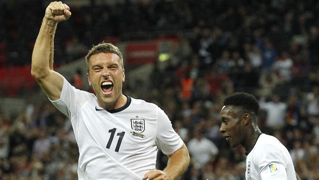 FILE - This is a Friday, Sept. 6, 2013 file photo of England's Rickie Lambert celebrates after scoring a goal during the World Cup group H qualifier soccer match between England and Moldova at Wembley Stadium in London. England striker Rickie Lambert Monday June 2, 2014 joined Liverpool from Southampton for a reported fee of 4 million pounds ($6.7 million), strengthening the team’s attacking options ahead of its return to the Champions League. Released by his boyhood club as a 15-year-old, Lambert returns to Anfield after spending most of his career as a journeyman in England’s lower leagues before making his name with Southampton since 2009. (AP Photo/Sang Tan, File)