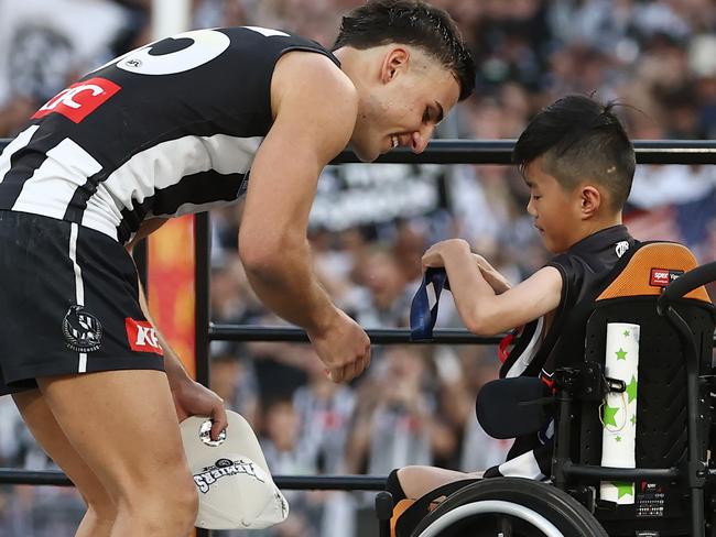 MELBOURNE , AUSTRALIA. September 30, 2023. AFL Grand Final between Collingwood and the Brisbane Lions at the MCG.   Nick Daicos of the Magpies receives his premiership medal  .Picture by Michael Klein