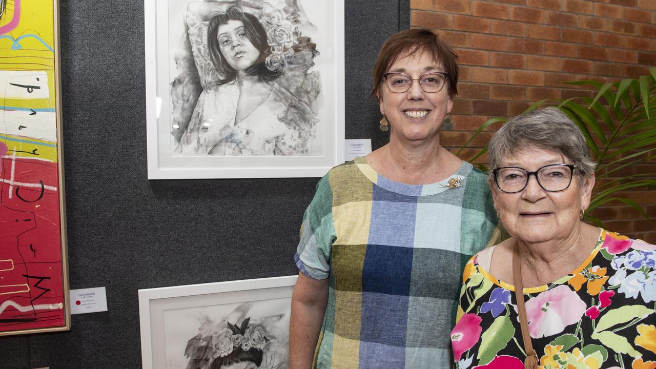 Peta and Jacki Harvey with Peta's charcoal drawings at the Toowoomba Grammar School Art Show. Saturday, March 25, 2023. Picture: Nev Madsen.