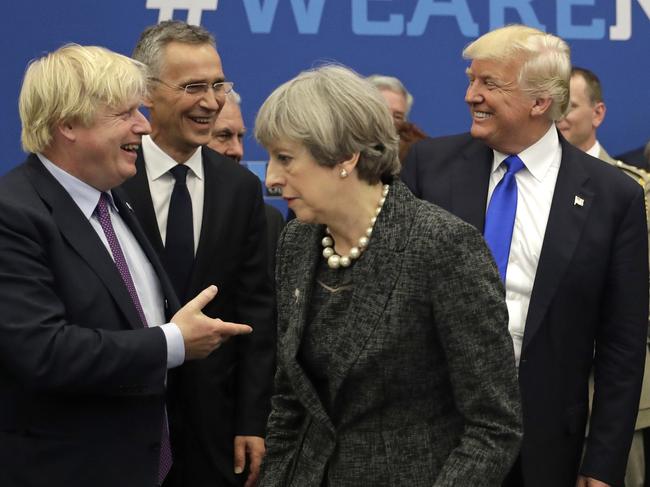 FILE - In this Thursday, May 25, 2017 file photo U.S. President Donald Trump jokes with British Foreign Minister Boris Johnson as British Prime Minister Theresa May walks past during a working dinner meeting at the NATO headquarters during a NATO summit of heads of state and government in Brussels. (AP Photo/Matt Dunham, Pool, File)