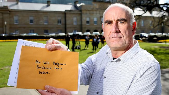 James Boyce with the letter to Will HOdgman from 75 Tasmanian business owners calling on the political leaders to remove pokies from pubs and clubs. Picture: SAM ROSEWARNE