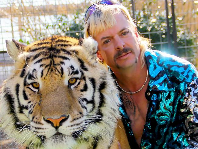 (FILES) In this file photo taken on January 20, 2020 this undated photo courtesy of Netflix shows Joseph "Joe Exotic" Maldonado-Passage with one of his tigers. - The US Justice Department said May 20, 2021 that it had seized 68 lions, tigers and lion-tiger hybrids as well as a jaguar from the former animal park of Joe Exotic, the star of the Netflix hit "Tiger King." (Photo by - / Netflix US / AFP) / RESTRICTED TO EDITORIAL USE - MANDATORY CREDIT "AFP PHOTO / NETFLIX" - NO MARKETING - NO ADVERTISING CAMPAIGNS - DISTRIBUTED AS A SERVICE TO CLIENTS