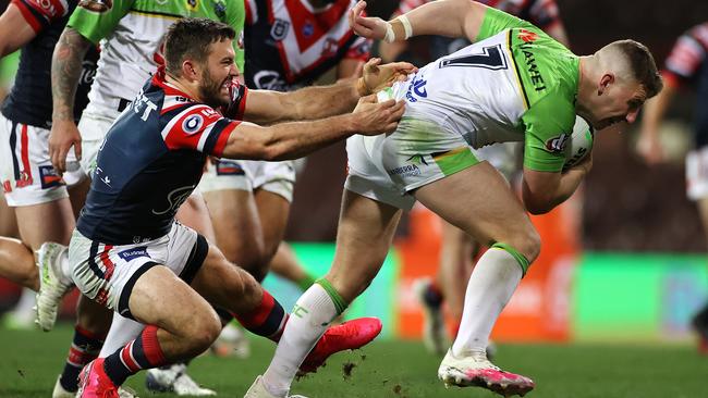 Halfback George Williams breaks through the tackle of Roosters fullback James Tedesco to score at the SCG. Picture. Phil Hillyard