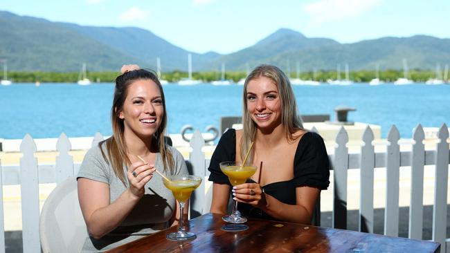 Melbourne tourists Emma Wooding and Ruby James make the most of the hot weather by cooling down with a frozen daiquiri overlooking the water at Hemingway's Brewery. Picture: Brendan Radke