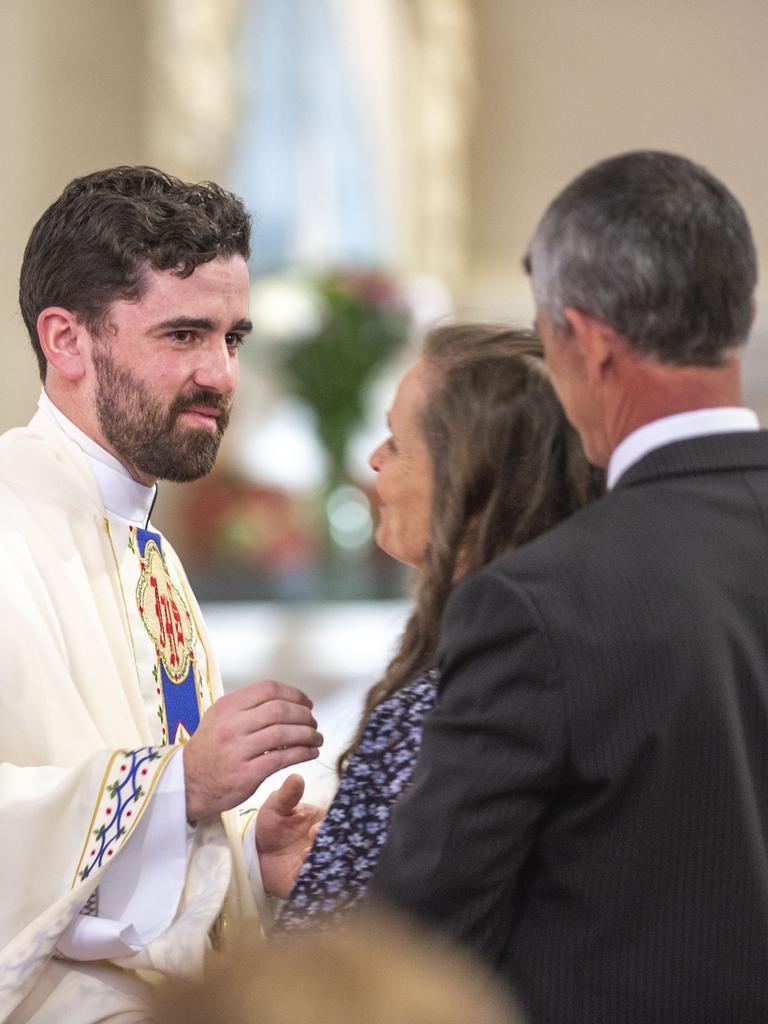 Newly ordained Fr Nathan Webb is congratuled by his parents Fiona and Paul Webb in St Patrick’s Cathedral. Picture: Nev Madsen.