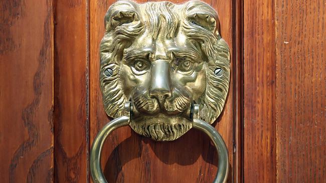 Oak door with brass lion head knocker.