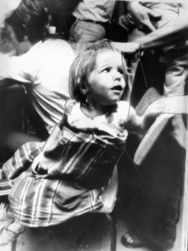 A young girl wrapped in a tablecloth in a relief centre in Alice Springs. .