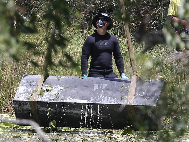 Toolbox murder -  Police retrieve a metal box from a dam near Srubby Creek in Kingston, double murder Logan. Pic Jono Searle.