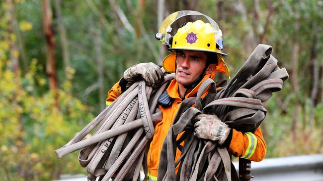 CFS volunteer and Liberal Party candidate for Morialta Scott Kennedy helping stop a fire at Black Hill Conservation Reserve in 2019. Picture: AAP/Mark Brake