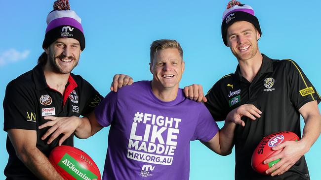 Josh Bruce (left) with Nick Riewoldt and Richmond’s David Astbury to promote Maddie’s Match. Picture: Ian Currie