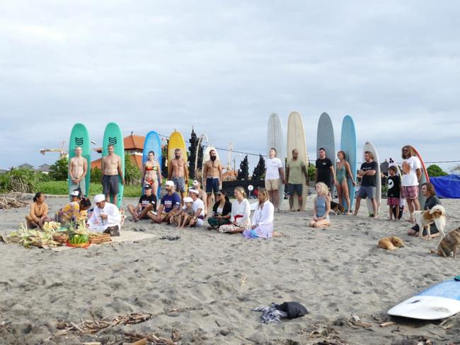 Paddlers in Bali prepare to pay their respects to those who have died as a result of child abuse or suicide. 