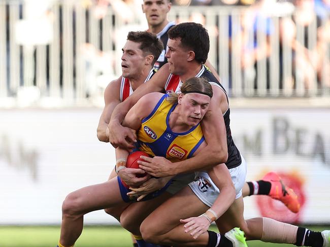 PERTH, AUSTRALIA - JUNE 01: Harley Reid of the Eagles gets tackled by Jack Steele and Rowan Marshall of the Saints during the round 12 AFL match between West Coast Eagles and St Kilda Saints at Optus Stadium, on June 01, 2024, in Perth, Australia. (Photo by Paul Kane/Getty Images)