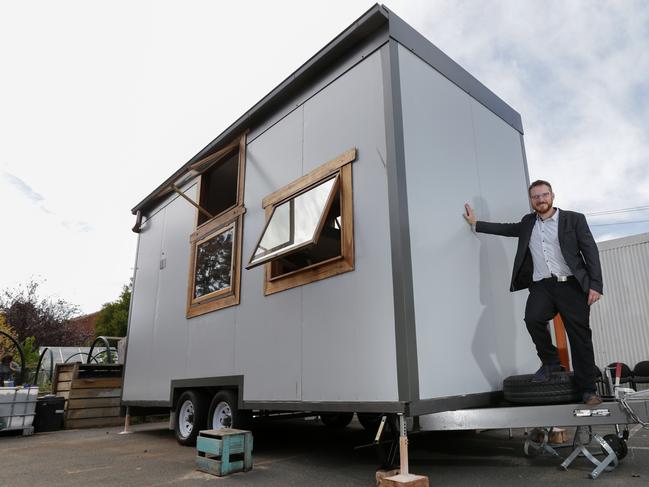 Builder Stuart Muir Wilson alongside his tiny home. Picture: George Salpigtidis