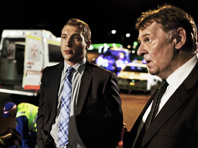 Suited up ... Jai Courtney (left) and Tom Wilkinson in a scene from Felony.