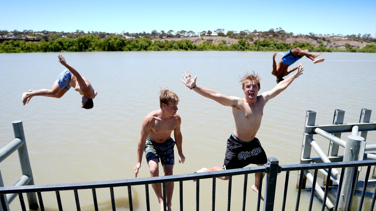 Tyson Naismith, 16, Cooper Wilson,16, Ollie Bartlett,16, and Anthony Kartinyeri, 17, keeping cool in the river. Picture: Dean Martin