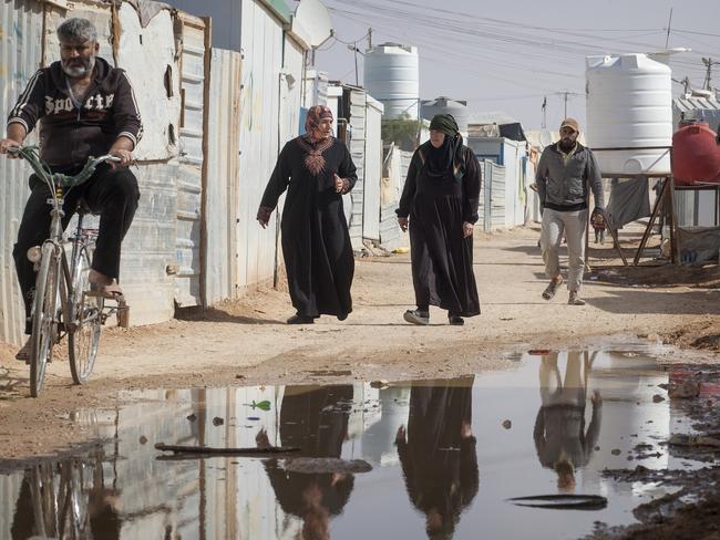 Displaced ... Refugees in the alleyways of the Za’atari camp. Picture: Ella Pellegrini