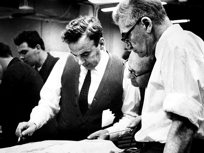 Directors' chairman Rupert Murdoch (L) Solly Chandler, chief make-up expert (R) and Hank Bateson, editorial manager looking at a page one proof for The Australian newspaper in Canberra, 15/07/1964. Pic News Limited.