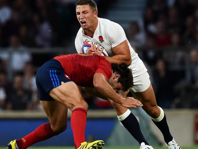 Sam Burgess tries to bust through the tackle of Remi Lamerat.