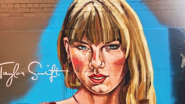 A huge Taylor Swift mural has popped up in Sydney ahead of her arrival for her three shows, but the artwork has received mixed reviews. The large portrait of Swift is on Crown Street in Surry Hills and portrays her wearing a red wrap dress, with her eyes angled downward. Picture: Instagram