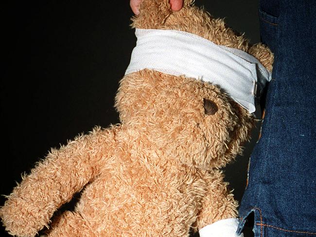 Child carrying teddy bear wearing bandages 13 Mar 2004. abuse