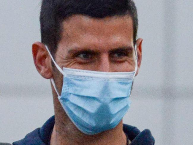 Serbian tennis player Novak Djokovic arrives before heading straight to quarantine for two weeks isolation ahead of their Australian Open warm up matches in Adelaide on January 14, 2021. (Photo by Brenton EDWARDS / AFP)