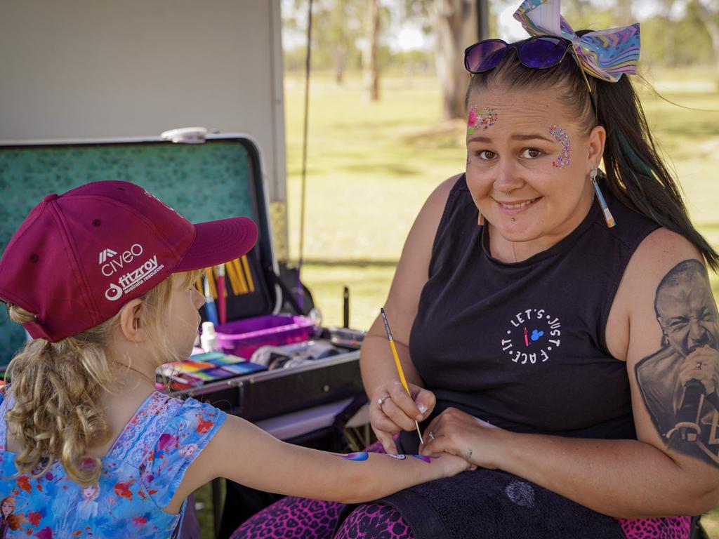 Let's Just Face It's Jess Reichelt, of Moranbah, painting a design on Gemma Petith, 6, of North Mackay, at the 40th birthday celebrations of Coppabella State School. Picture: Heidi Petith