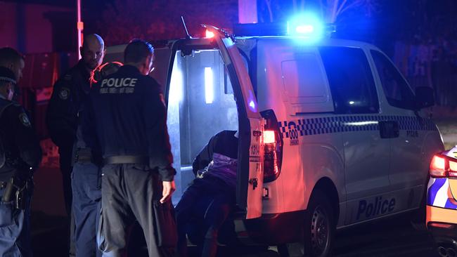 A man is arrested at the scene last night. Picture: Gordon McComiskie