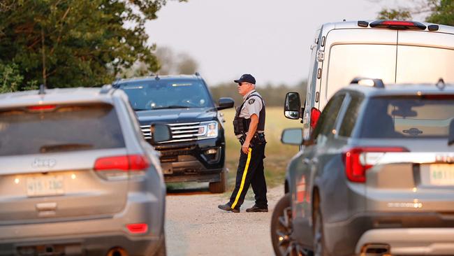 A Royal Canadian Mounted Police officer arrives at one of the 13 crime scenes, as part of a stabbing spree investigation in Weldon, Saskatchewan, Canada. Picture: Reuters/David Stobbe