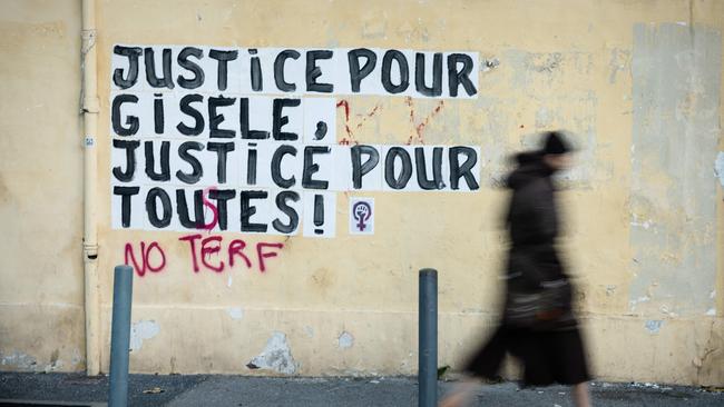 A pedestrian walks past a collage mural reading "Justice for Gisele, Justice for all" near the Avignon courthouse. Picture: Clement Mahoudeau/AFP