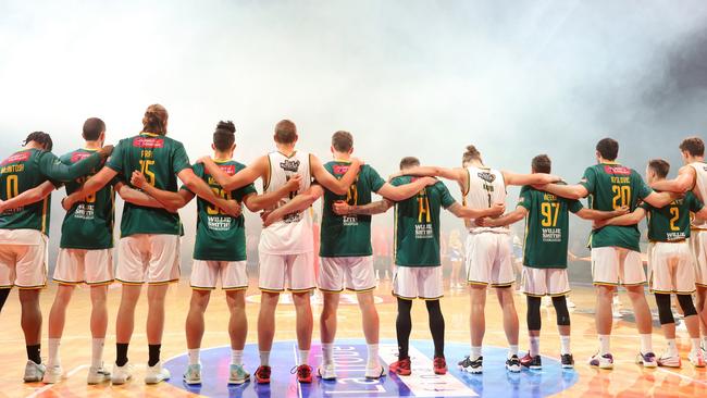 The JackJumpers stand for a moments silence in Perth in a mark of respect for the lives lost at Hillcrest Primary School. Picture: Getty Images