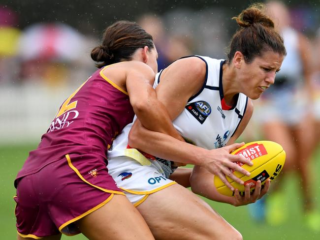 Jessica Foley (right) of the Crows is tackled by Sophie Conway (left) of the Lions during the Round 1 AFLW match between the Brisbane Lions and Adelaide Crows at Hickey Park in Brisbane, Saturday, February 8, 2020. (AAP Image/Darren England) NO ARCHIVING, EDITORIAL USE ONLY