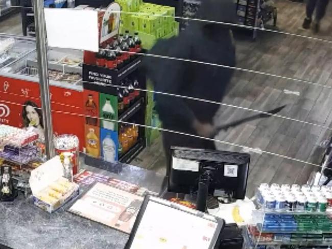 The group of men rush into the Glenroy servo on Pascoe Vale Rd armed with machetes and baseball bats before stealing cash and cigarettes. Picture: Victoria Police