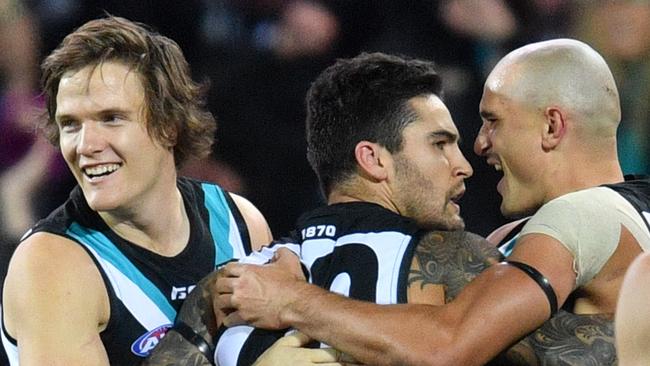 Jared Polec, Chad Wingard and Sam Powell-Pepper of the Power celebrate a goal in Showdown 44. Picture: Getty