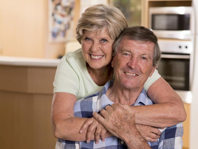 senior beautiful middle age couple around 70 years old smiling happy together at home kitchen looking sweet in lifetime husband and wife enjoying life and love concept; retirees, seniors generic