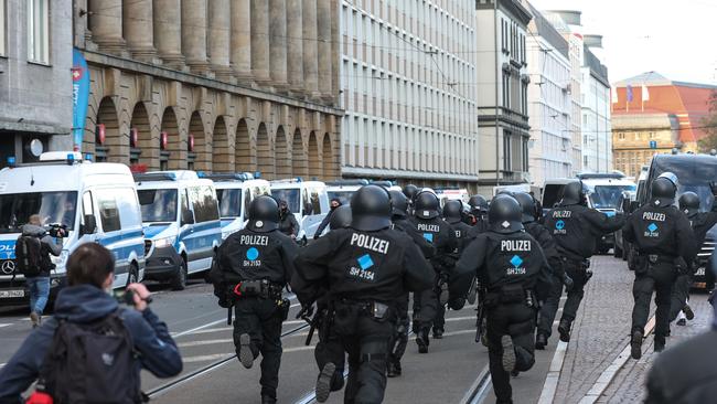 German police run during protests against restrictions imposed by the German government. Picture: AFP.