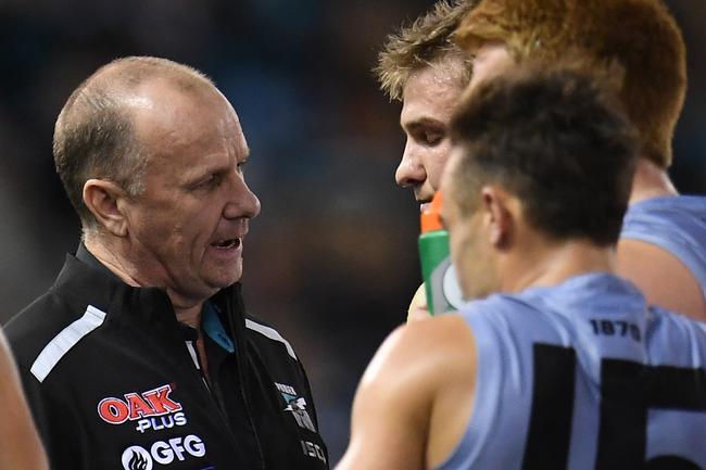 Power coach Ken Hinkley speaks to Port Adelaide co-captain Ollie Wines at the quarter-time break against Collingwood at Marvel Stadium in Melbourne. Picture: Julian Smith/AAP