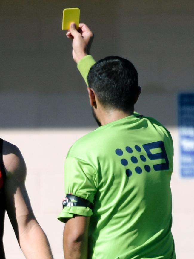 An umpire shows a player a yellow card during an Adelaide Footy League match. Picture: AAP/Morgan Sette