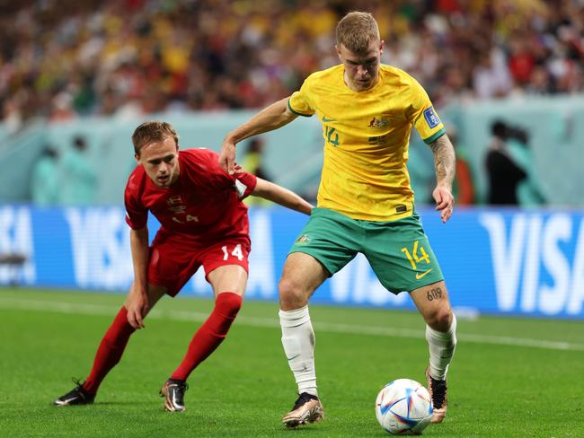 Riley McGree controls the ball under pressure from Mikkel Damsgaard. Picture: Dean Mouhtaropoulos/Getty Images