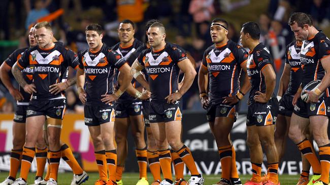 Dejected Tigers players watch as Cameron Smith converts a try.