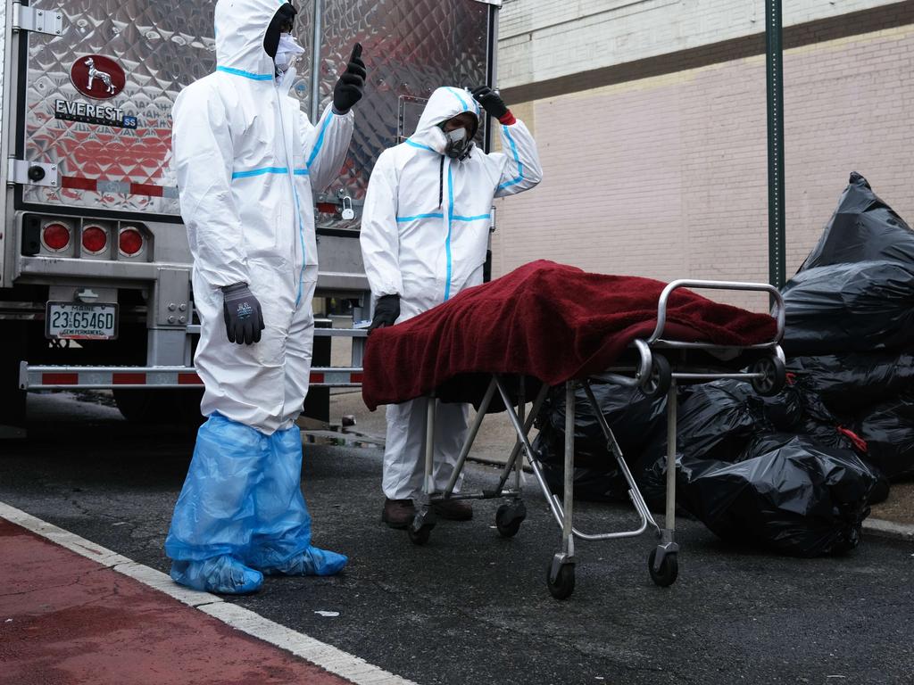 A body is moved on the street outside the Andrew Cleckley Funeral Home in New York in April. Picture: Spencer Platt/Getty Images/AFP