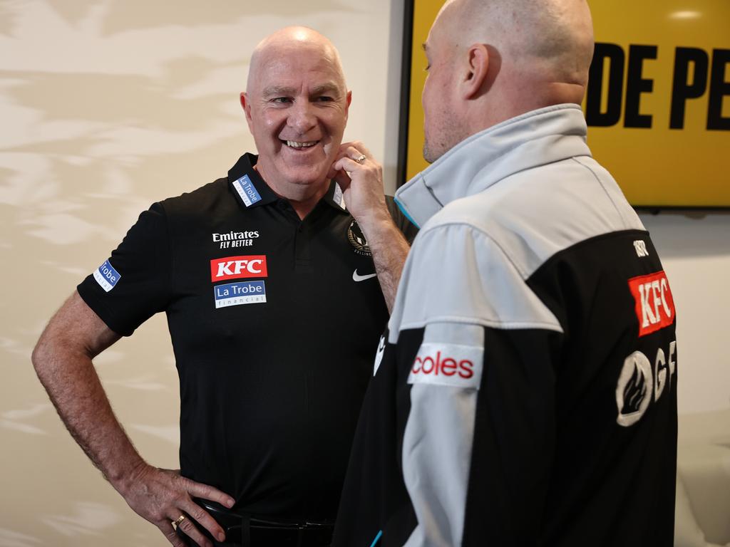 Graham Wright, GM of Football of the Magpies, speaking with Port Adelaide's Chris Davies in October 2022 in Melbourne.