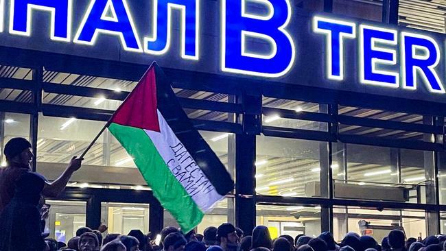 A local man waves a Palestinian flag during a pro-Palestinian rally at the Makhachkala Airport after the arrival of a scheduled flight from Tel Aviv. Picture: TASS/Sipa USA