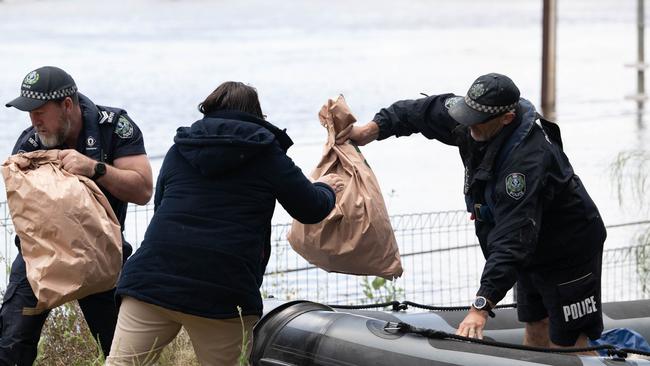 Police retrieving evidence from the lagoon. Picture: Morgan Sette