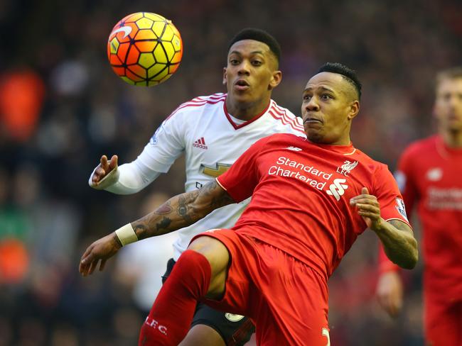 Nathaniel Clyne of Liverpool beats Anthony Martial of Manchester United to the ball.