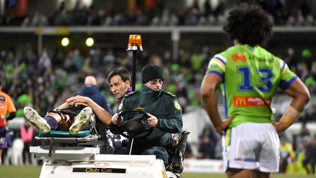 Sia Soliola watches on as Billy Slater is stretchered off the field.