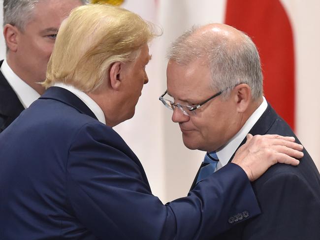 OSAKA, JAPAN - JUNE 29: Australia's Prime Minister Scott Morrison (R) chats with US President Donald Trump (C) prior to the session 3 on women's workforce participation, future of work, and aging societies at the G20 Summit on June 29, 2019 in Osaka, Japan. U.S. President Donald Trump and Chinese President Xi Jinping agreed to resume trade negotiations on Saturday during their meeting in Osaka at the annual Group of 20 summit, in an attempt to resolve a trade deal between the world's two largest economies. According to reports, both leaders agreed that the U.S. would not impose new tariffs during their discussion as world leaders met in Osaka during the two-day G20 summit to discuss economic, environmental and geopolitical issues. (Photo by Kazuhiro NOGI - Pool/Getty Images)