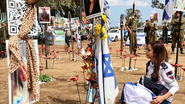 A visitor mourns at a memorial for people who were taken hostage or killed in the Hamas attack on the Supernova music festival on October 7, near Kibbutz Reim in southern Israel. The ICC prosecutor’s decision to seek an arrest warrant against Israel’s Prime Minister and Defence Minister obliterates the moral distinction between aggressor and victim, and empties the right to self-defence. Picture: AFP